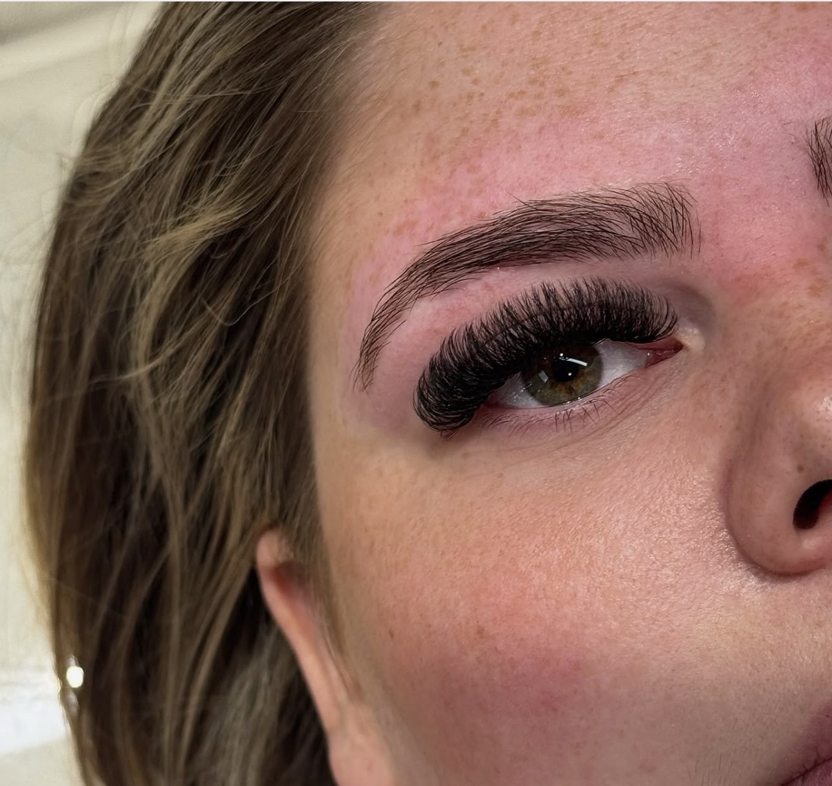 Close-up of dark volume lash extensions and a brushed-up brow, created at Dolls Beauty Room in Shirley, Southampton